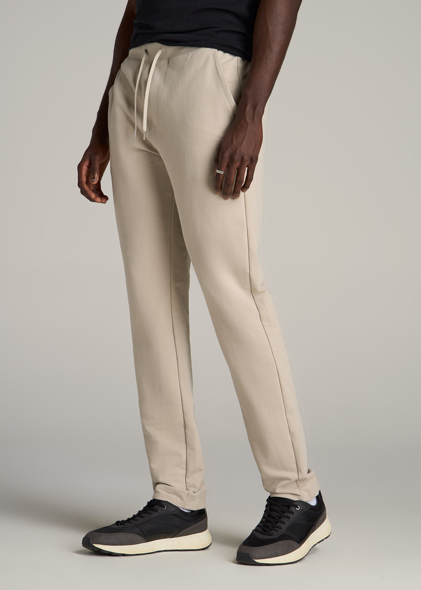 A tall man wearing American Tall's Microsanded French Terry Sweatpants For Tall Men in Stone.