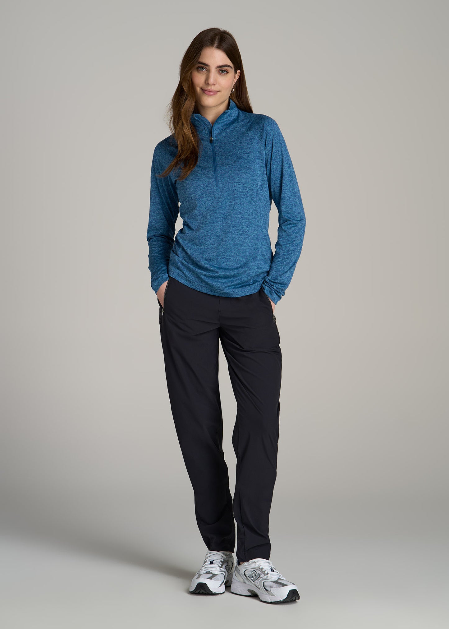 A tall woman wearing Long Sleeve Active Half Zip Pullover Tall Women's Jacket in Ocean Blue Space Dye from American Tall