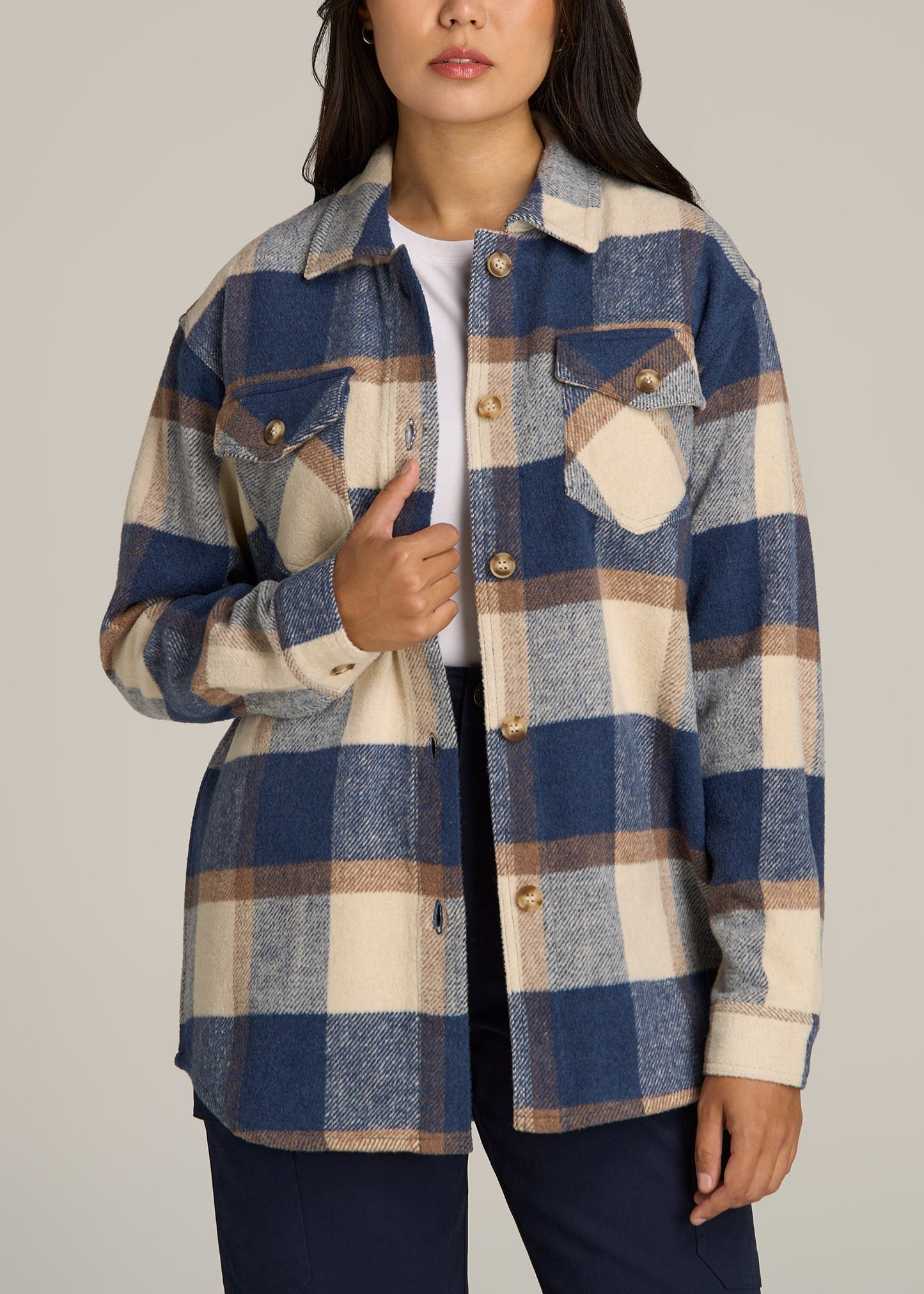 A tall woman wearing American Tall's Flannel Women's Tall Shacket in Cream and Denim Blue Paid.