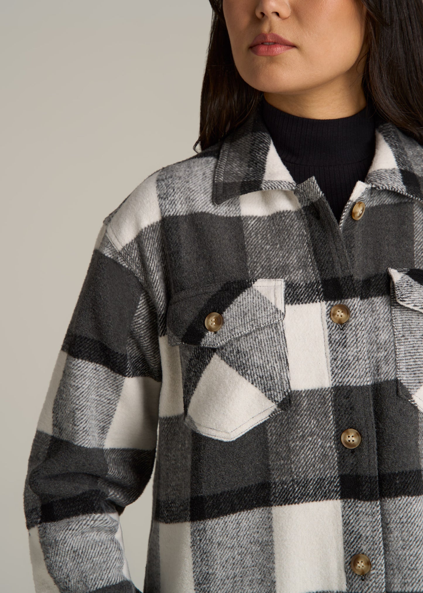 A tall woman wearing American Tall's Flannel Women's Tall Shacket in Grey and Black Plaid.