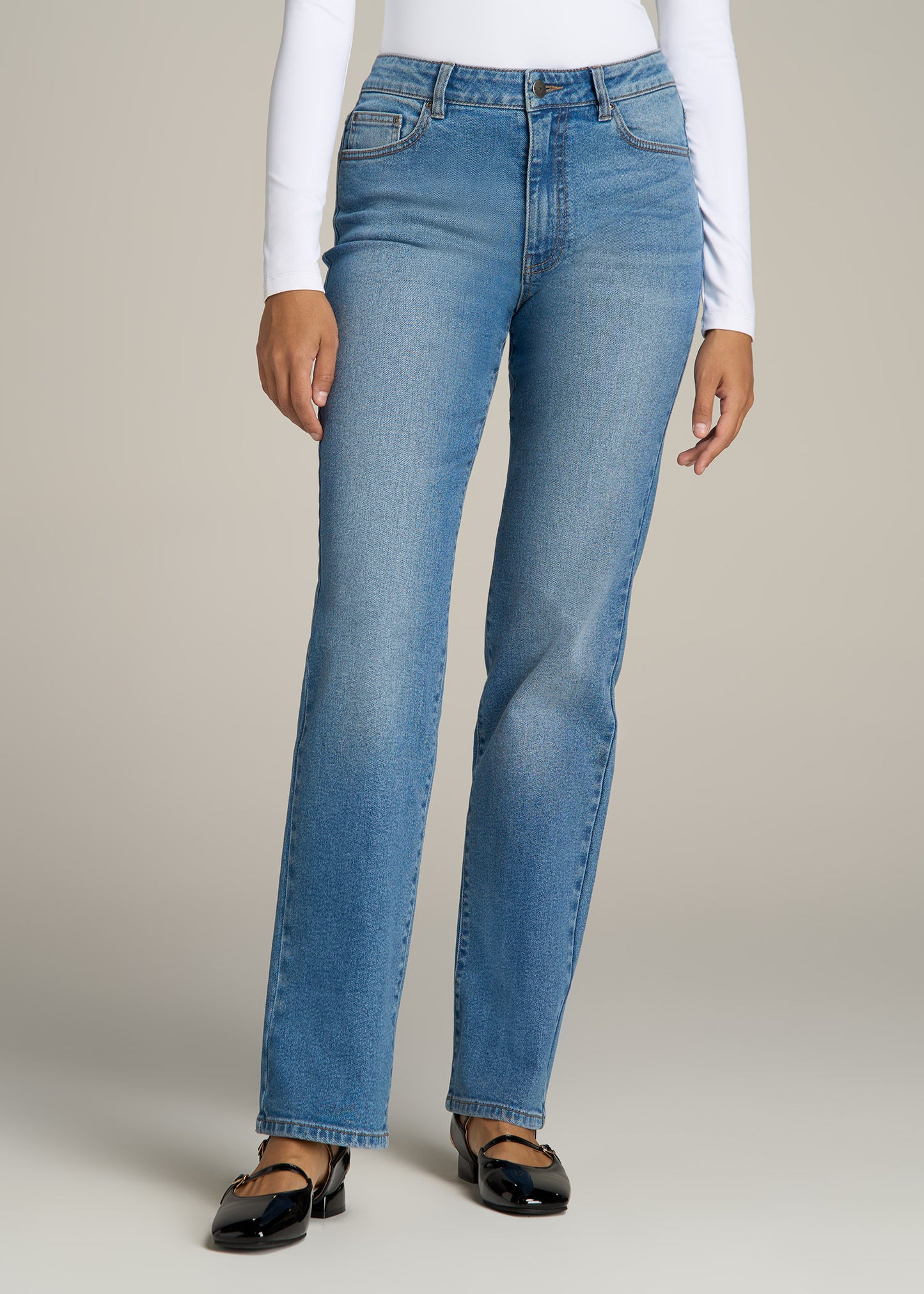 A tall woman wearing American Tall's Harper High-Rise Straight Stretch Jeans in Colorado Blue.