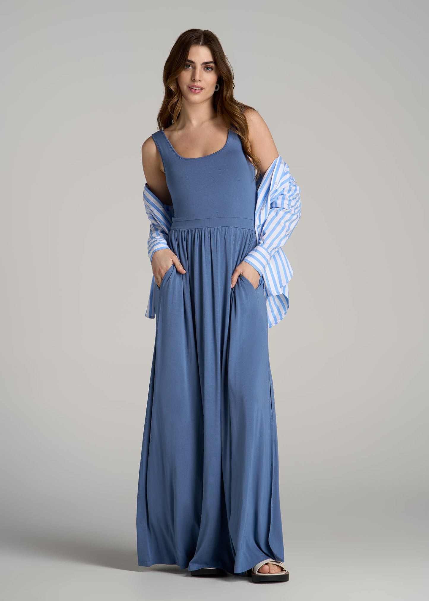 A tall woman wearing American Tall's Jersey Tank Maxi Dress with Pockets for Tall Women in Steel Blue