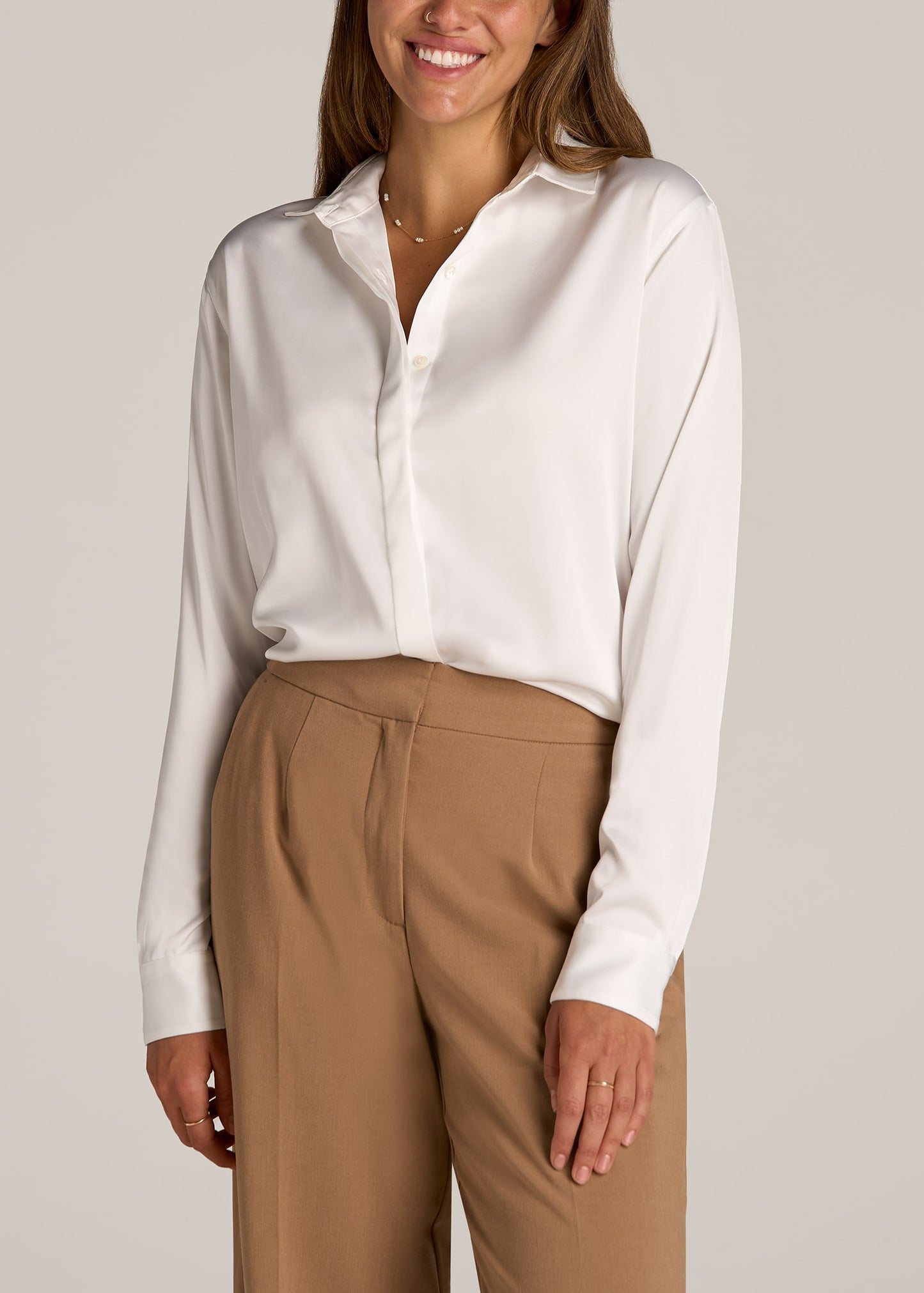 A tall woman wearing American Tall's Relaxed Button Up Tall Women's Blouse in the color Pearl White.