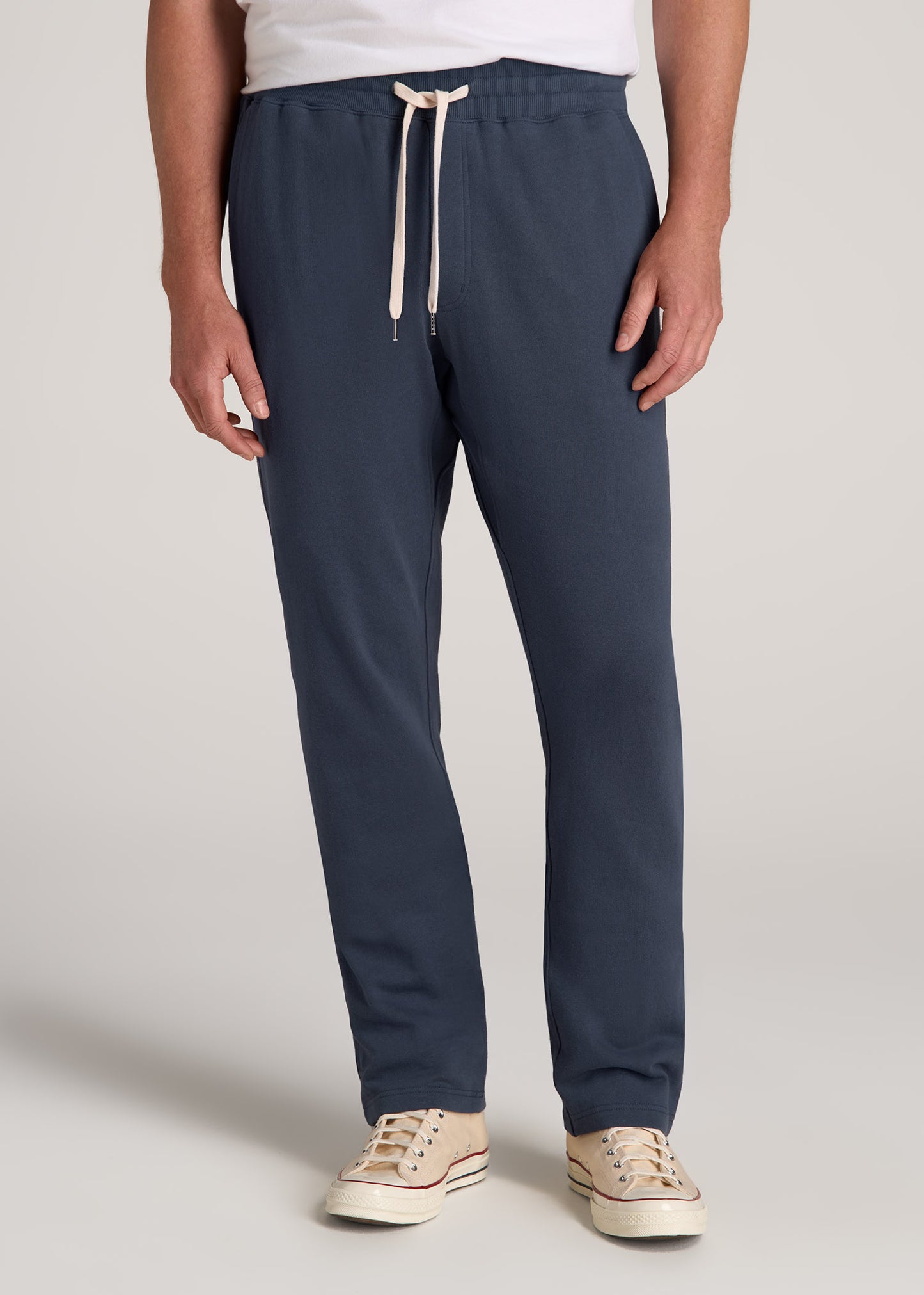 A tall man wearing American Tall's LJ&S Brushed Terrycloth Sweatpants for Tall Men in Vintage Midnight Navy.