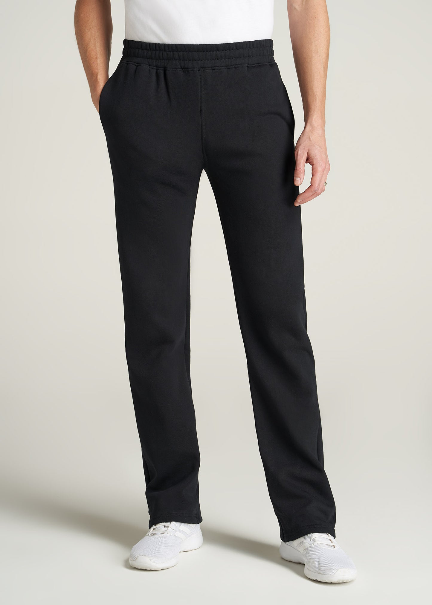 A tall man wearing American Tall's Wearever Fleece Open-Bottom Sweatpants for Tall Men in Black.