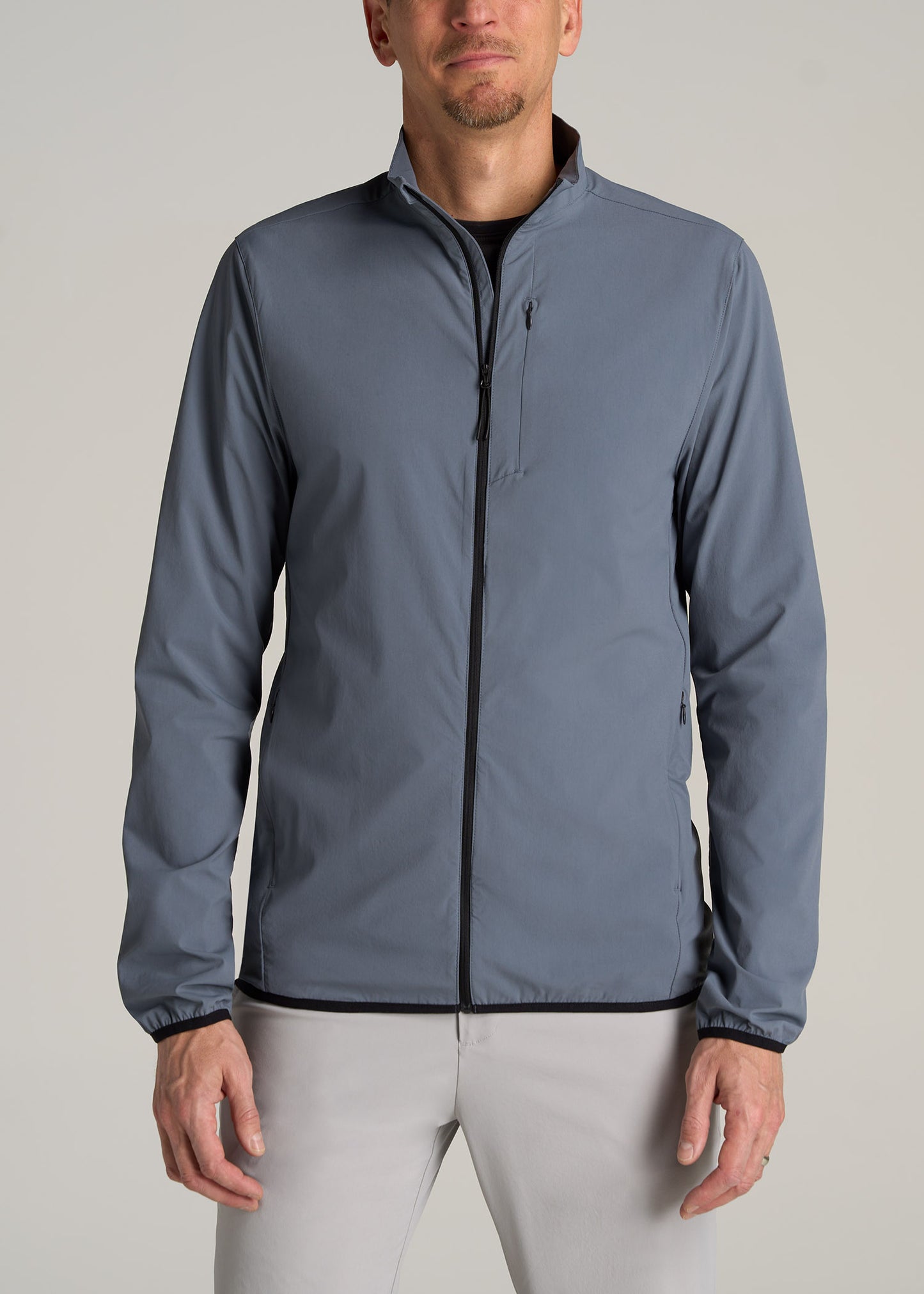 A tall man wearing American Tall's Tall Men's Softshell Jacket for Outdoor Training in Smoky Blue.