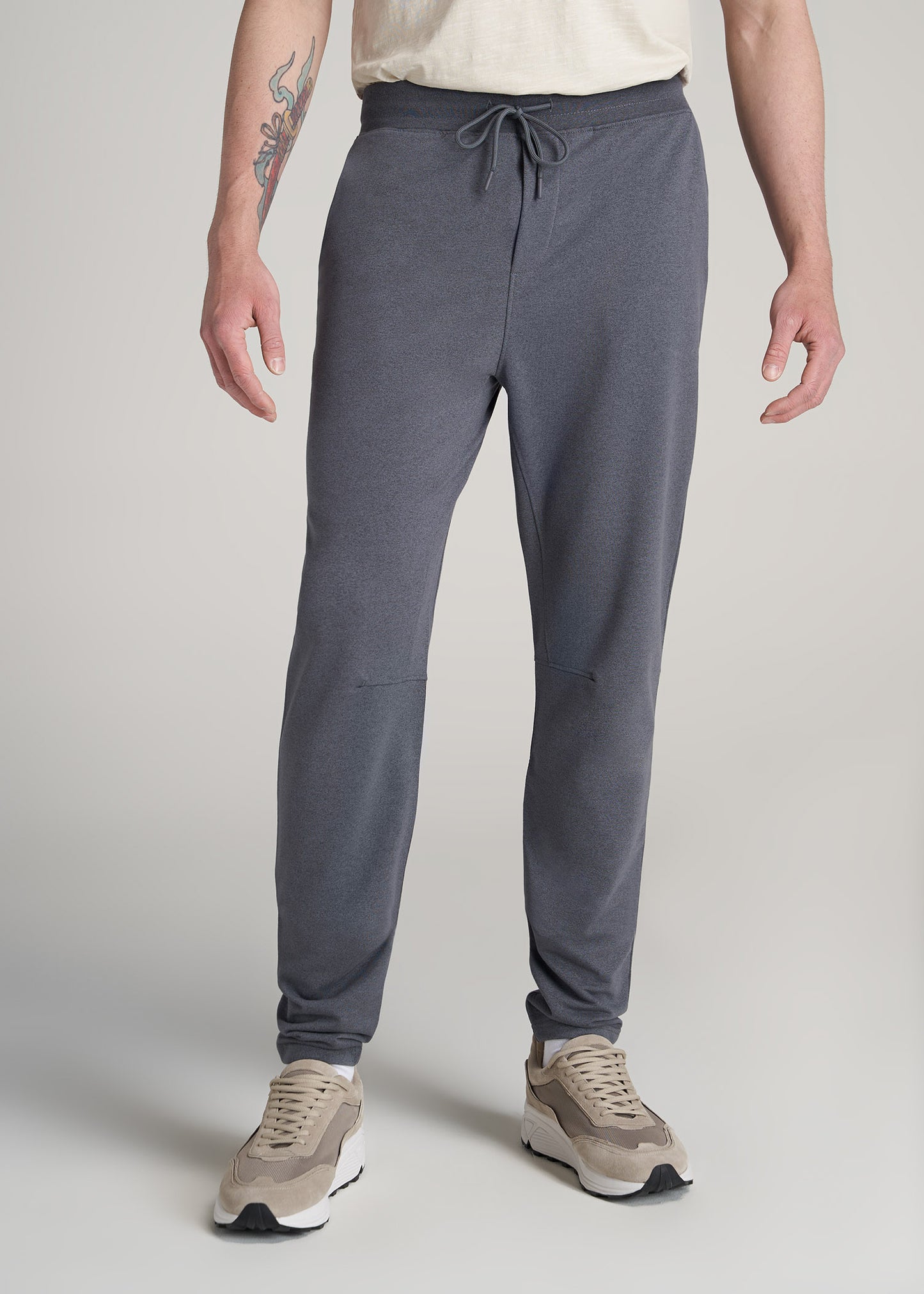 A tall man wearing American Tall's Performance French Terry Sweatpants for Tall Men in Charcoal Mix.