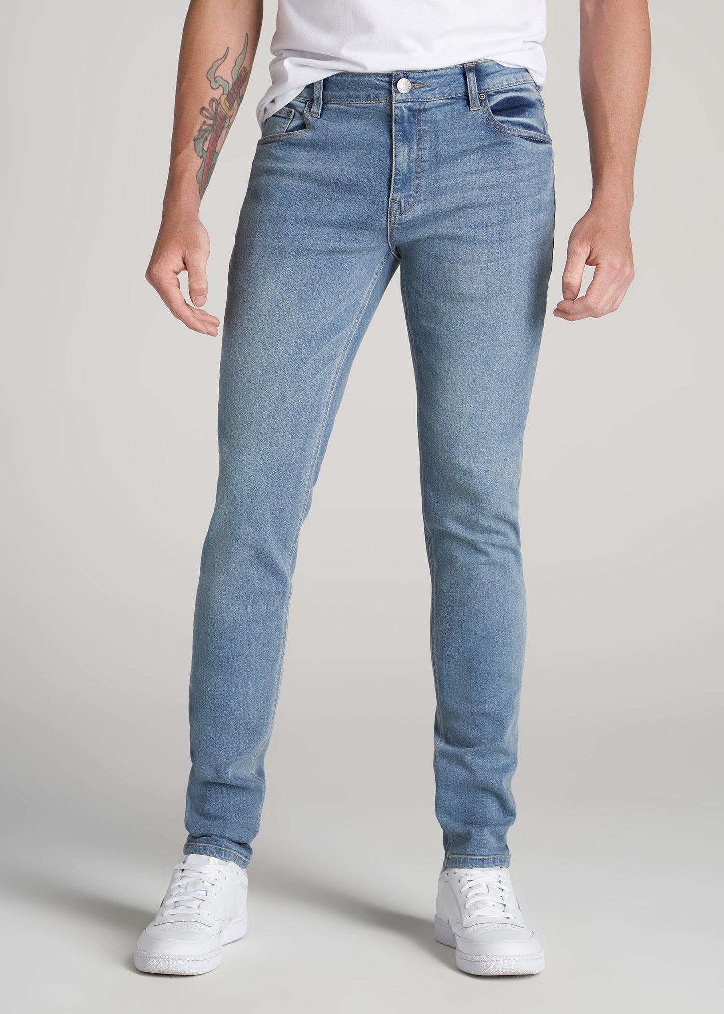 A tall man wearing American Tall's Travis Skinny Jeans for Tall Men in New Fade.
