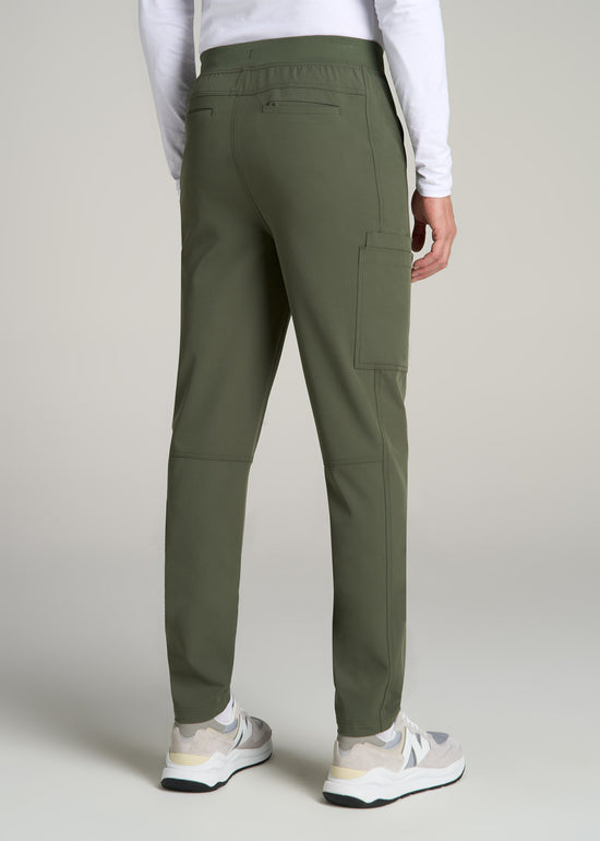 A tall man wearing American Tall's Cargo Scrub Pants in the color Clover Green.