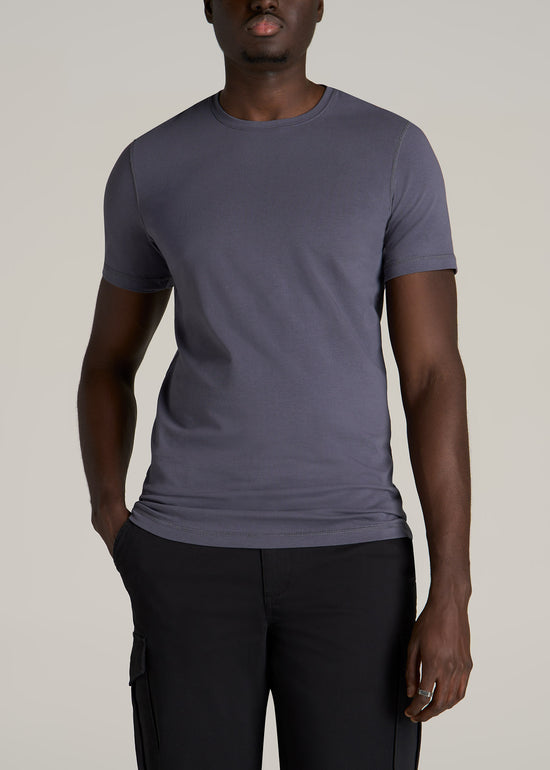Tall slim man wearing American Tall's essential slim-fit crew neck tee in a grey-blue color.