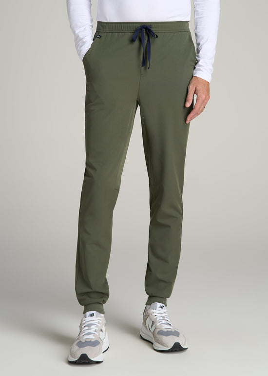 A tall man wearing American Tall's Scrub Joggers in the color Clover Green.