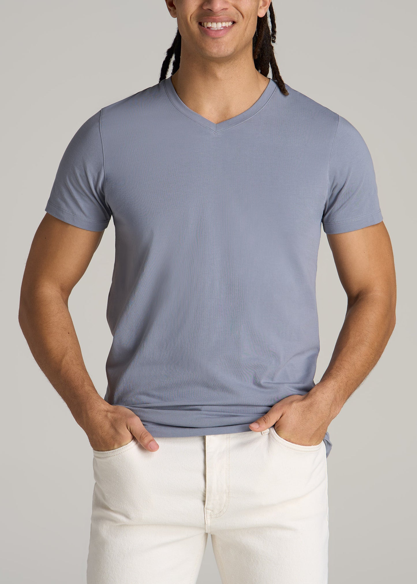 A tall man wearing American Tall's Stretch Cotton MODERN-FIT V-Neck T-Shirt for Tall Men in Skyline Grey.