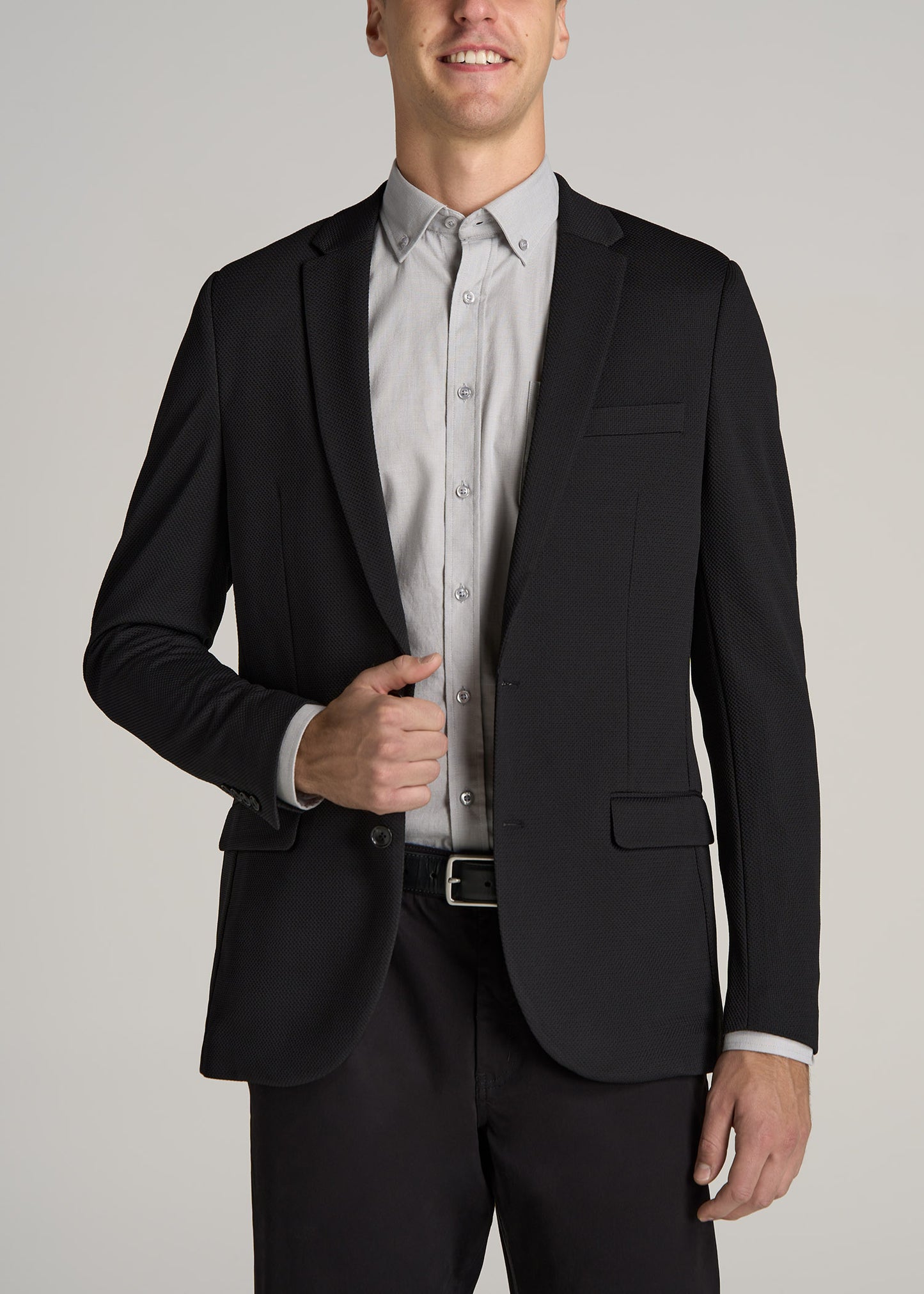 A tall man wearing American Tall's Textured Blazer for Tall Men in Black.