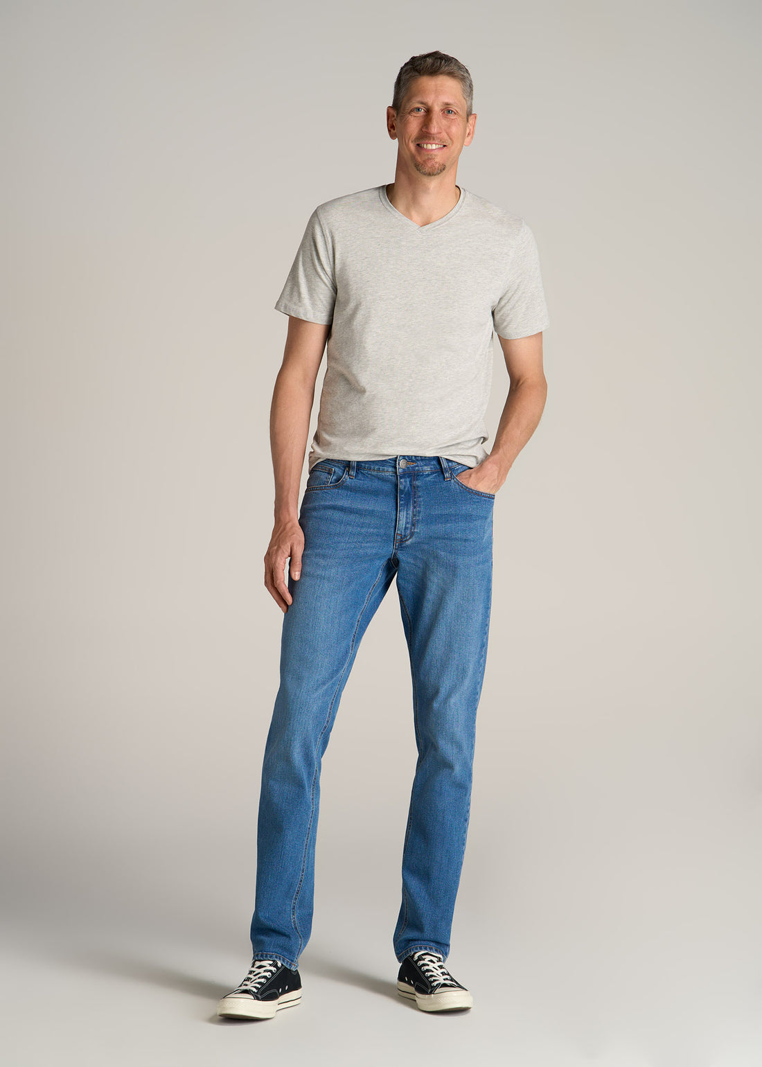 A tall man wearing American Tall's Essential REGULAR-FIT V-Neck Men's Tall Tees in the color Grey Mix.
