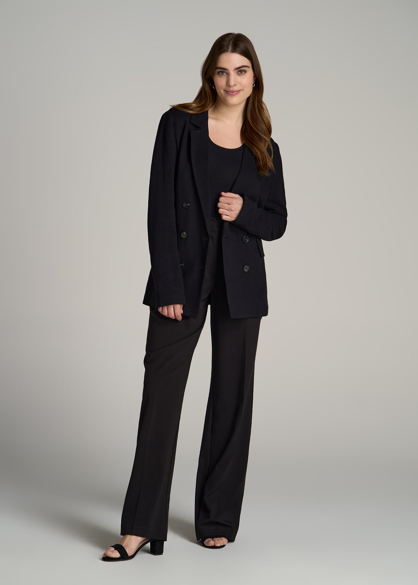 A tall woman wearing American Tall's Soft Shoulder Tie-Back Blazer in Black.