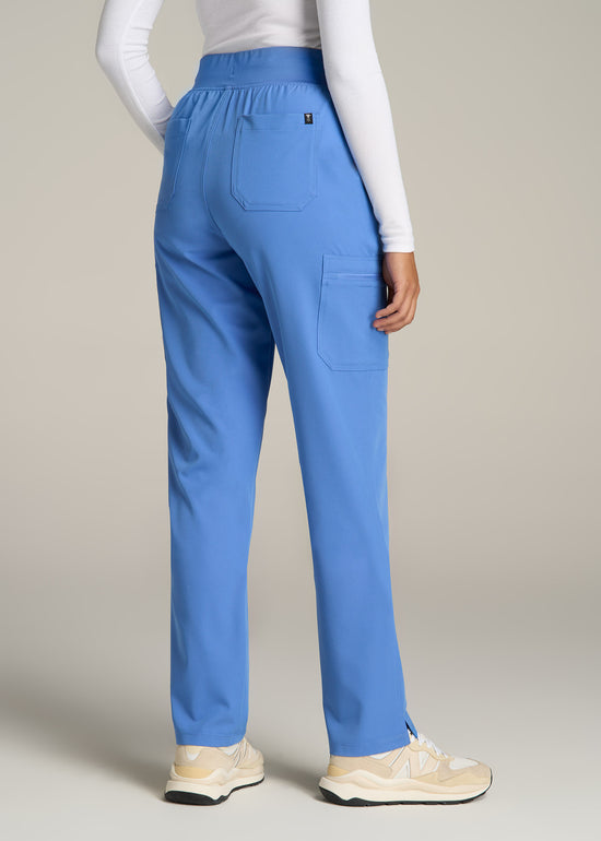 A tall woman wearing American Tall's Cargo Scrub Pants in the color Deep Sky Blue.