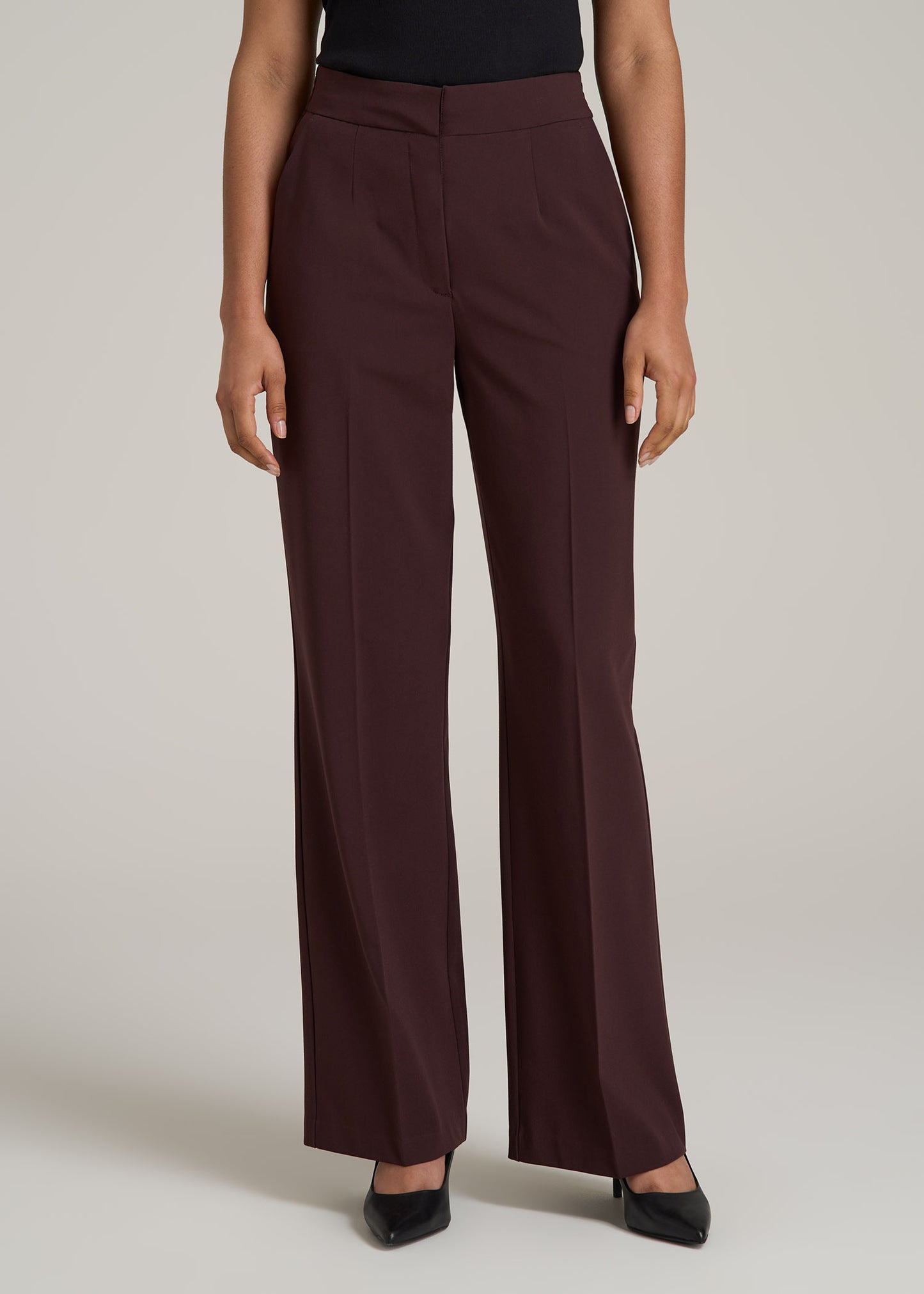 A tall woman wearing American Tall's Flat Front Wide Leg Dress Pants for Tall Women in Oxblood