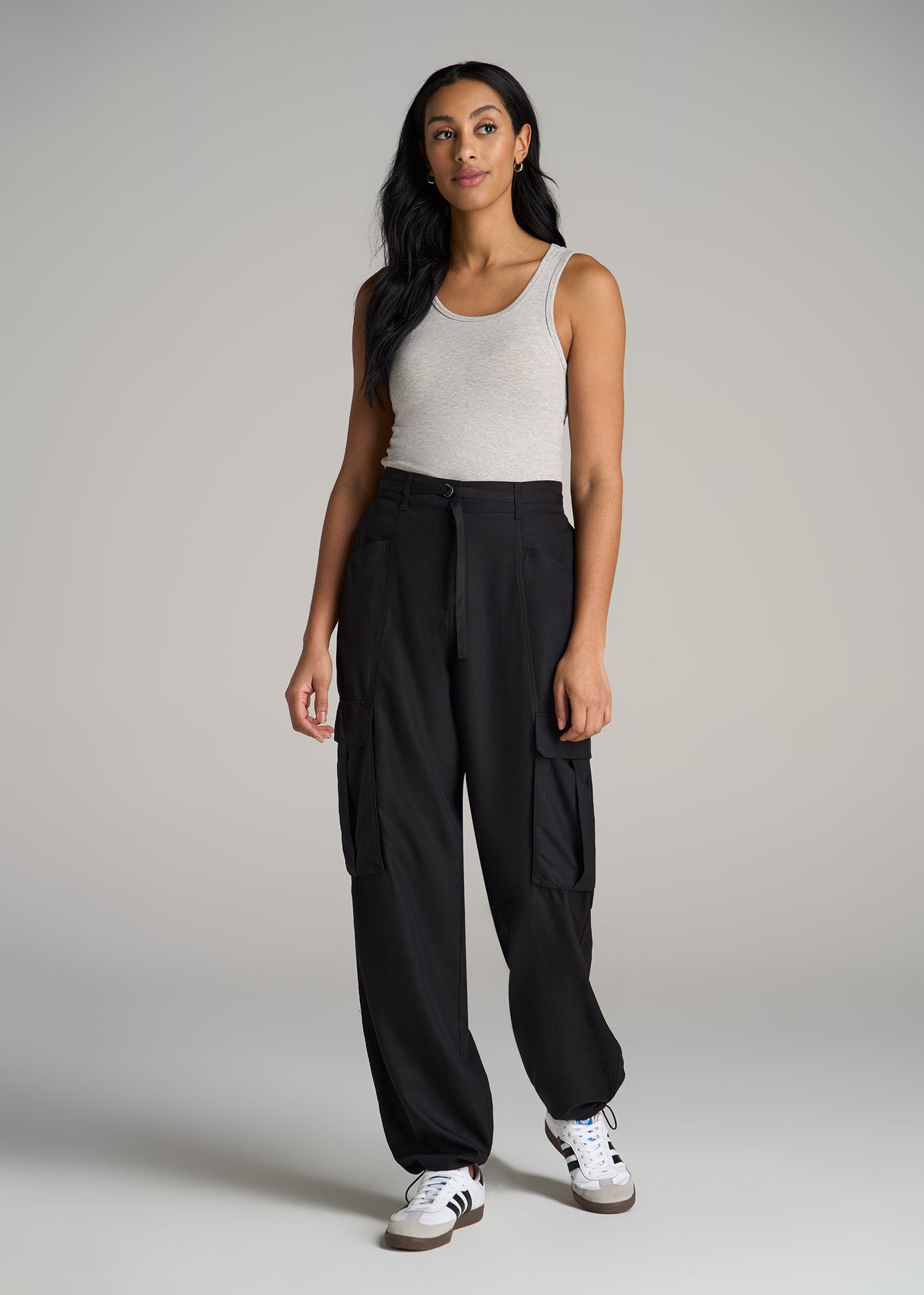 A tall woman wearing High Rise Cargo Parachute Pants for Tall Women in Black from American Tall