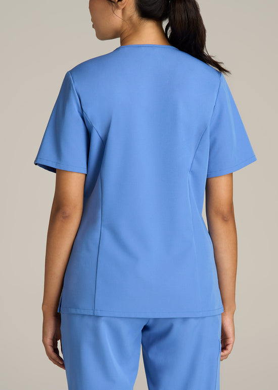 A tall woman wearing American Tall's Short Short Sleeve V-Neck Scrub Top in the color Deep Sky Blue.