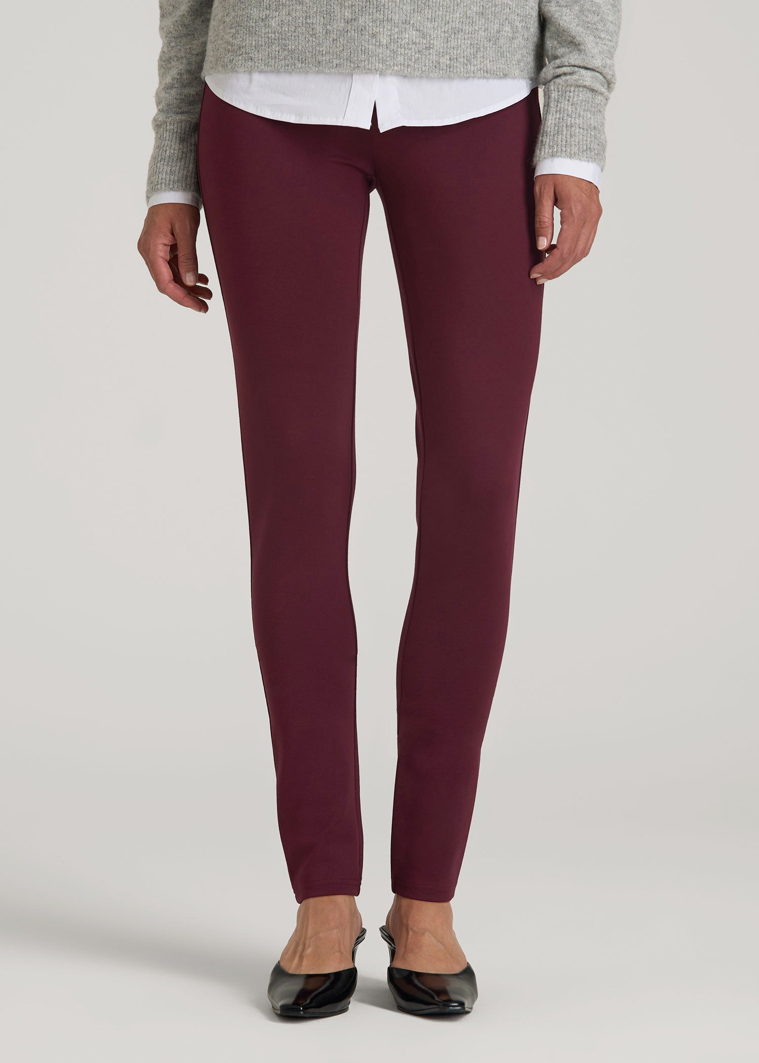 A tall woman wearing American Tall's Soft Flex Ponte Skinny High Rise Pant for Tall Women