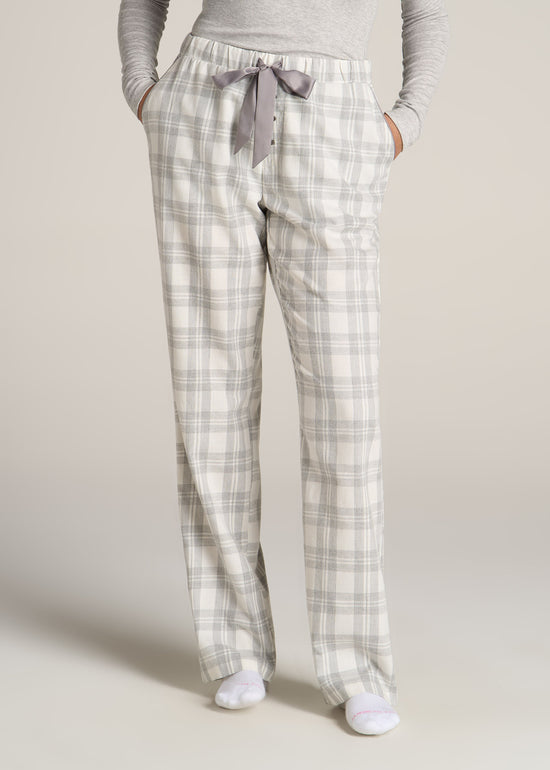 A tall woman wearing American Tall's Open-Bottom Flannel Pajama Pants in the color Heather Grey and White Plaid.
