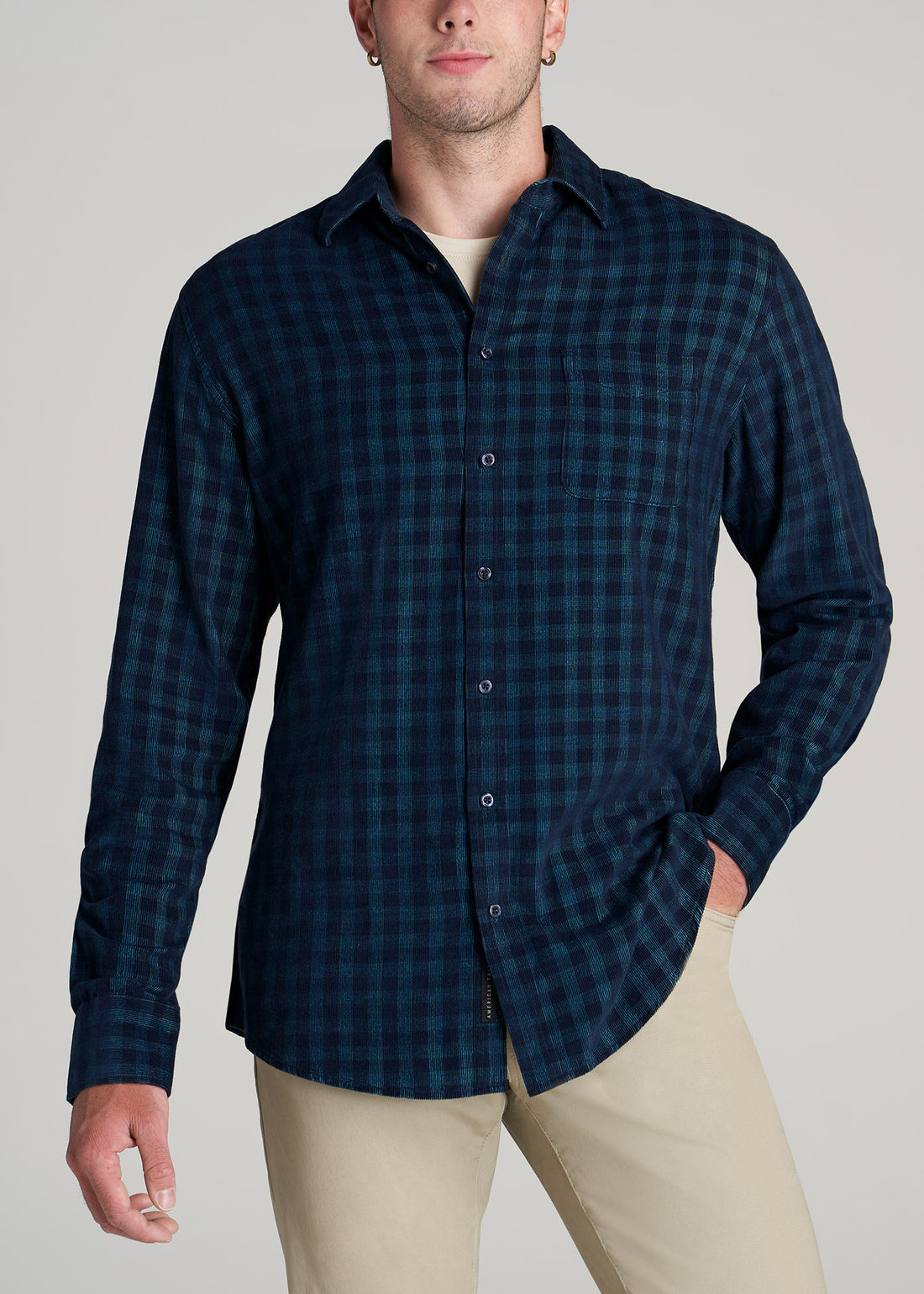 Tall man wearing American Tall's Baby Wale Corduroy Button Shirt in Teal and Navy Plaid.