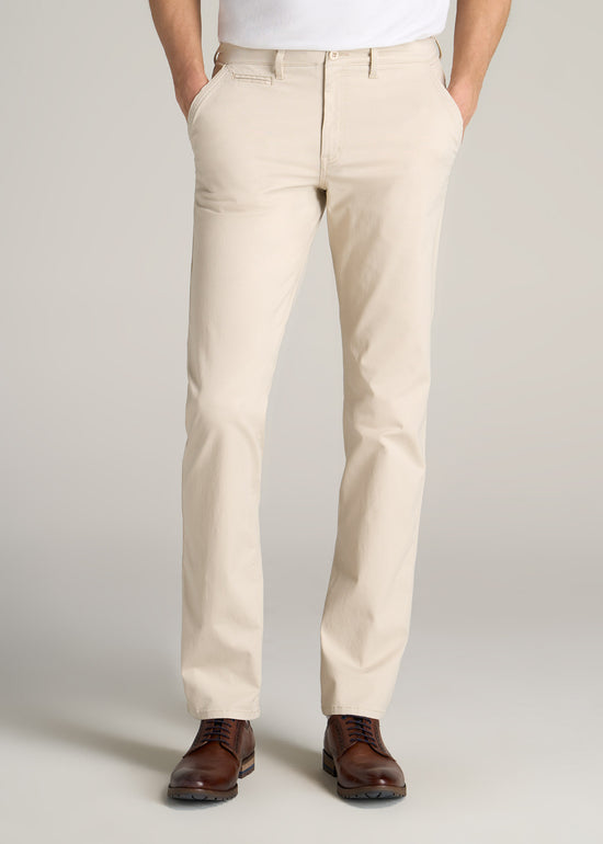 Tall guy wearing American Tall's Carman Tapered Fit Chino Pant in the color Soft Beige.