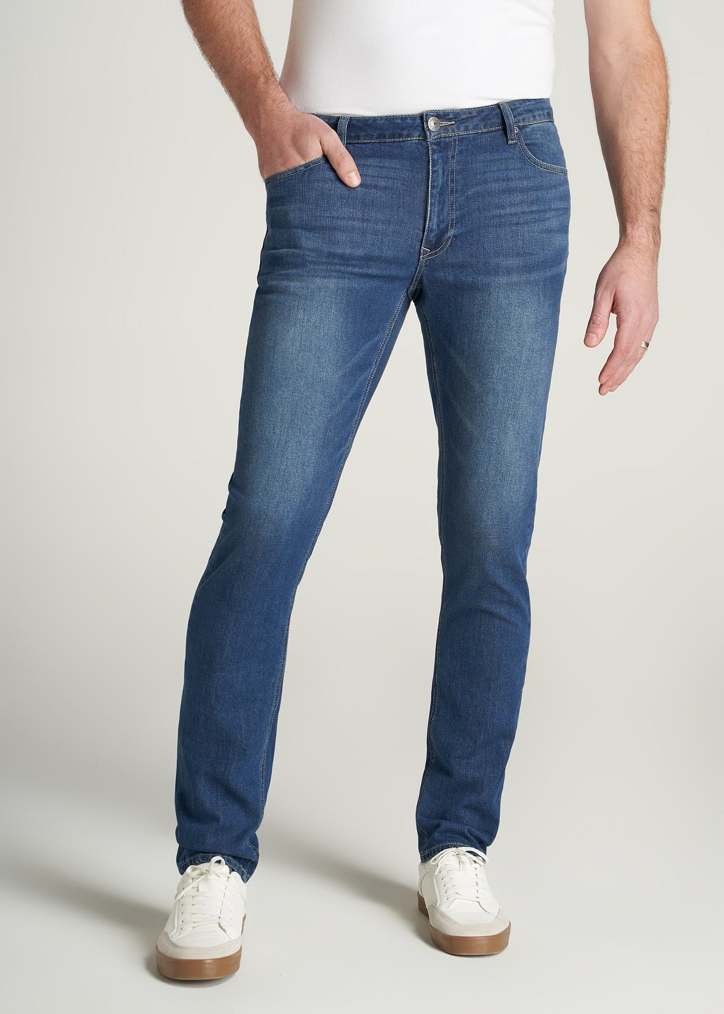 Tall guy wearing American Tall's Carman Tapered Jeans in the color Classic Blue.