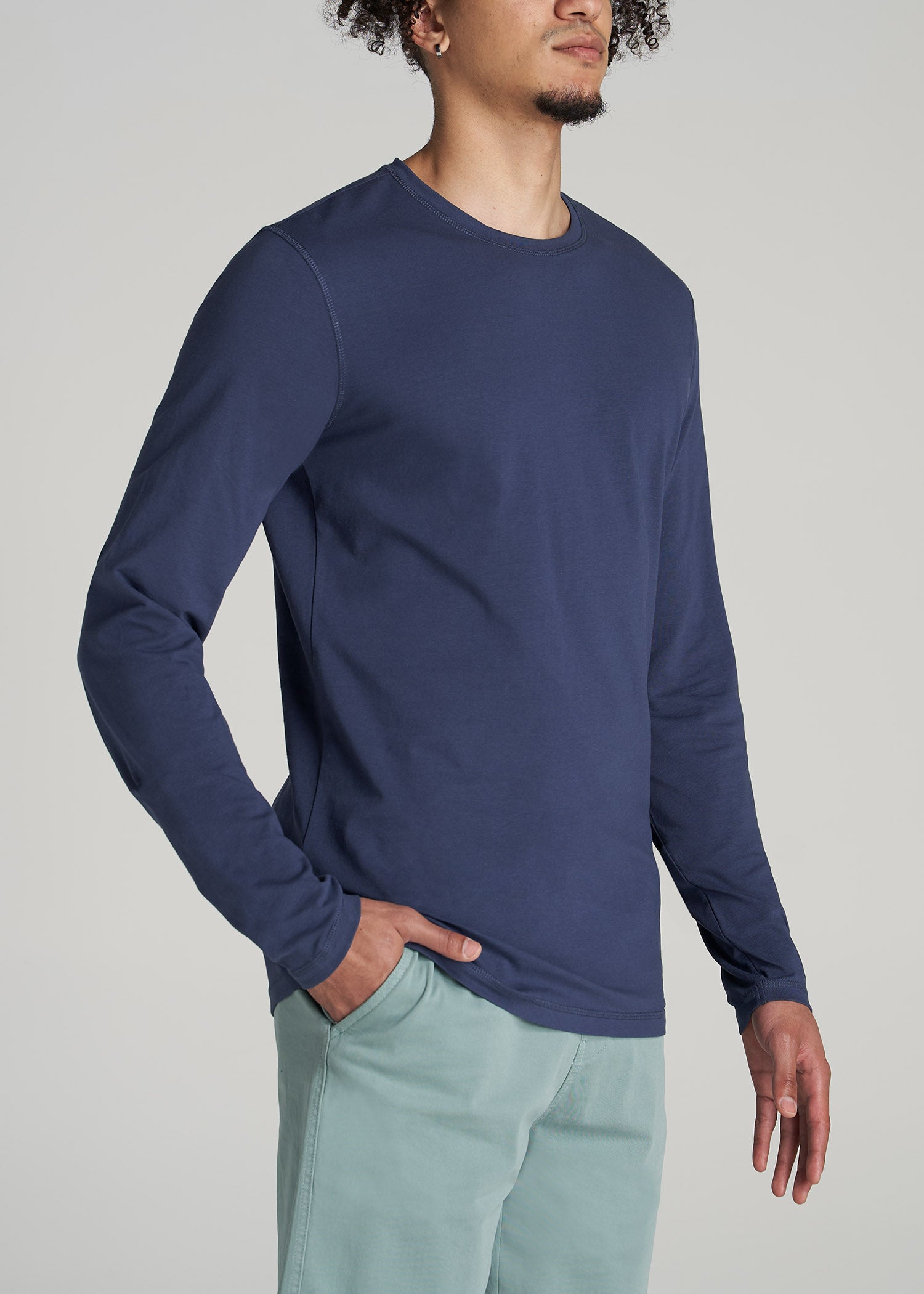 Semi-tall man wearing American Tall's Original Essentials Slim-Fit Long-Sleeve T-Shirt in the color Navy.