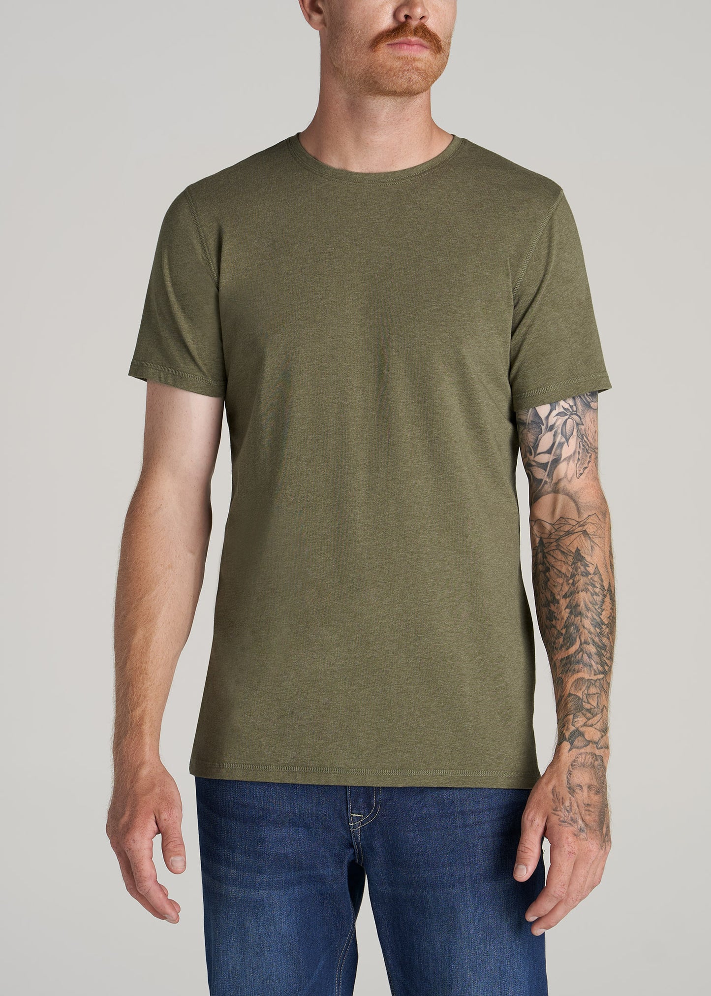 A tall man wearing a slim-fit crewneck t-shirt in olive green.