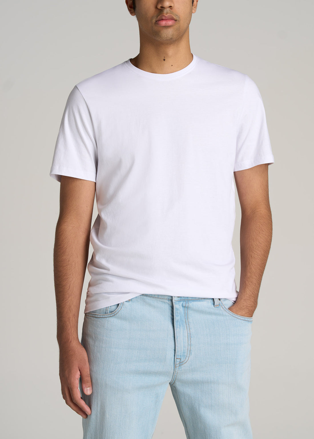 A tall man wearing a classic crewneck t-shirt in white.