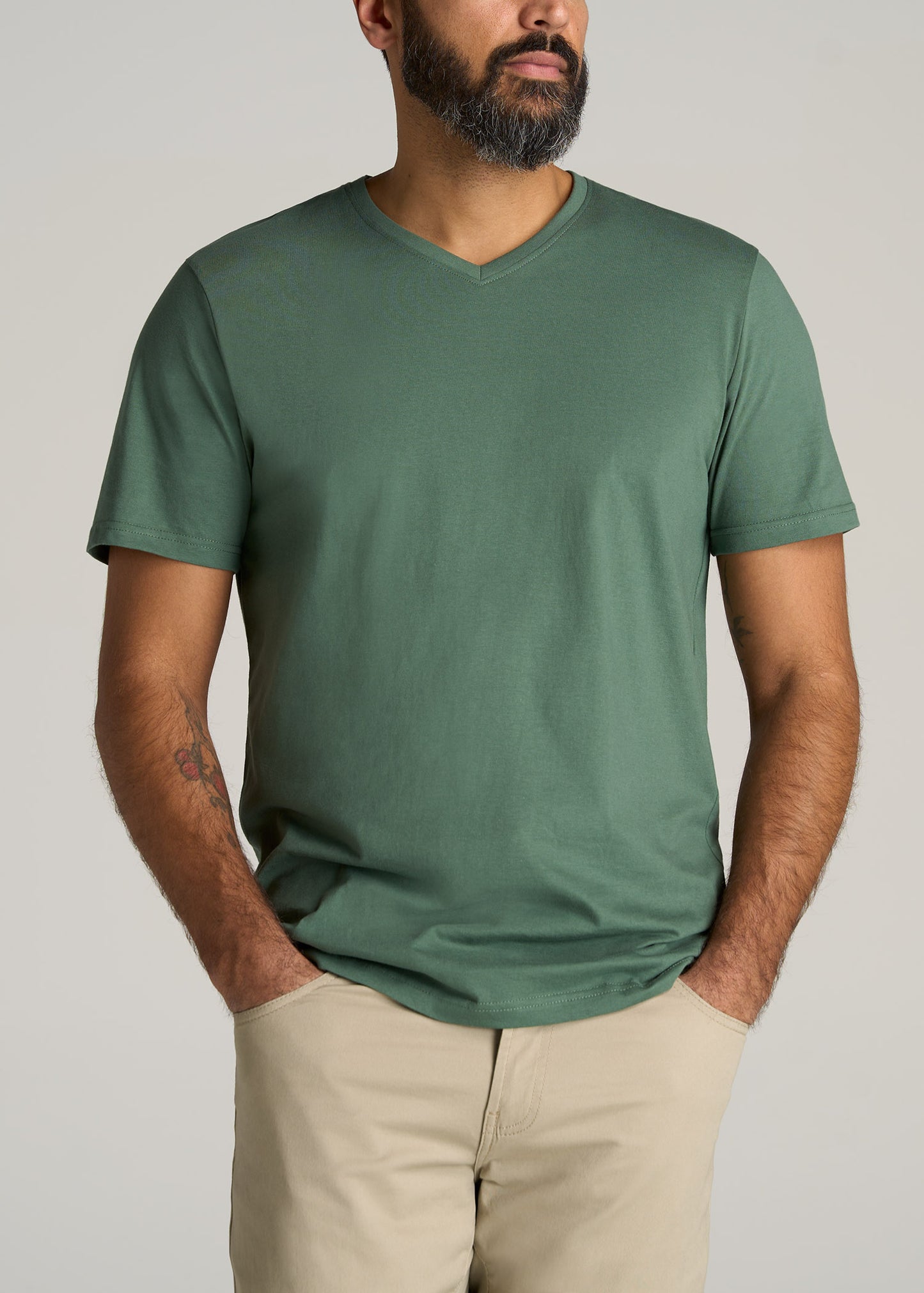 A tall man wearing American Tall's The Everyday REGULAR-FIT V-Neck Tall Men's T-Shirt in Forest Green.