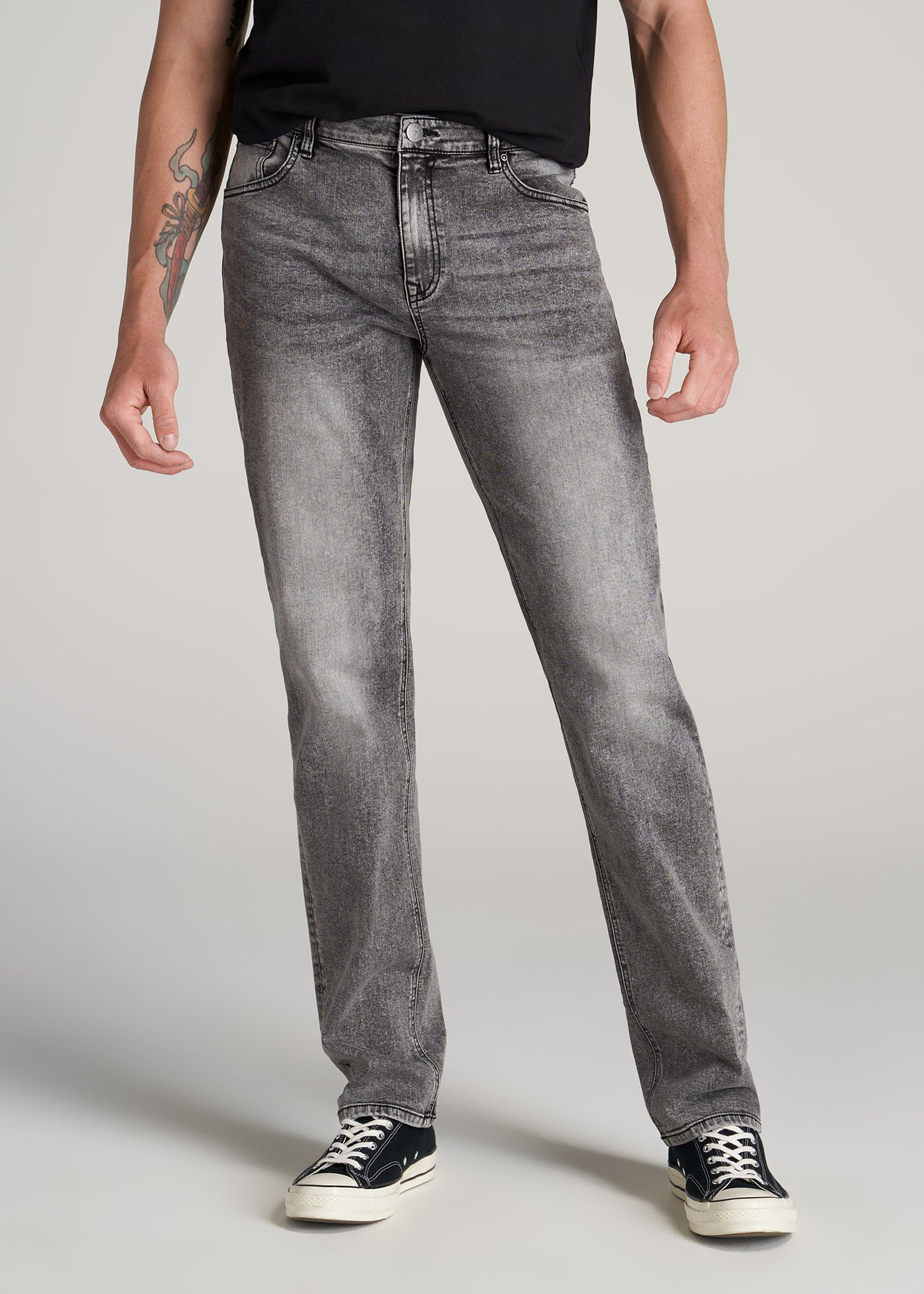 Tall guy wearing American Tall's J1 Straight-Leg Jeans in the color Washed Faded Black.