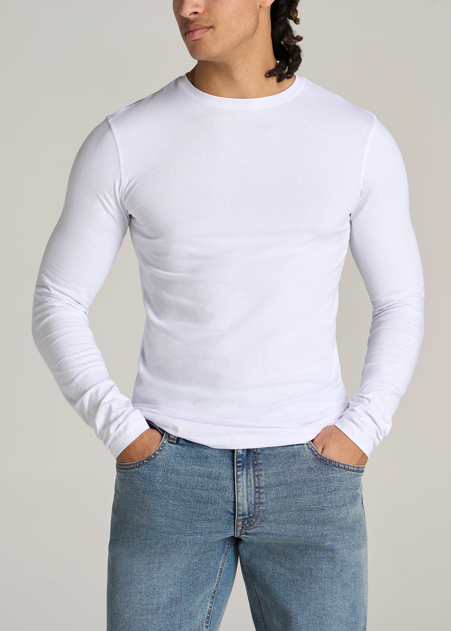 A tall man wearing American Tall's Original Essentials Slim-Fit Long Sleeve Tall Men's T-Shirt in White.