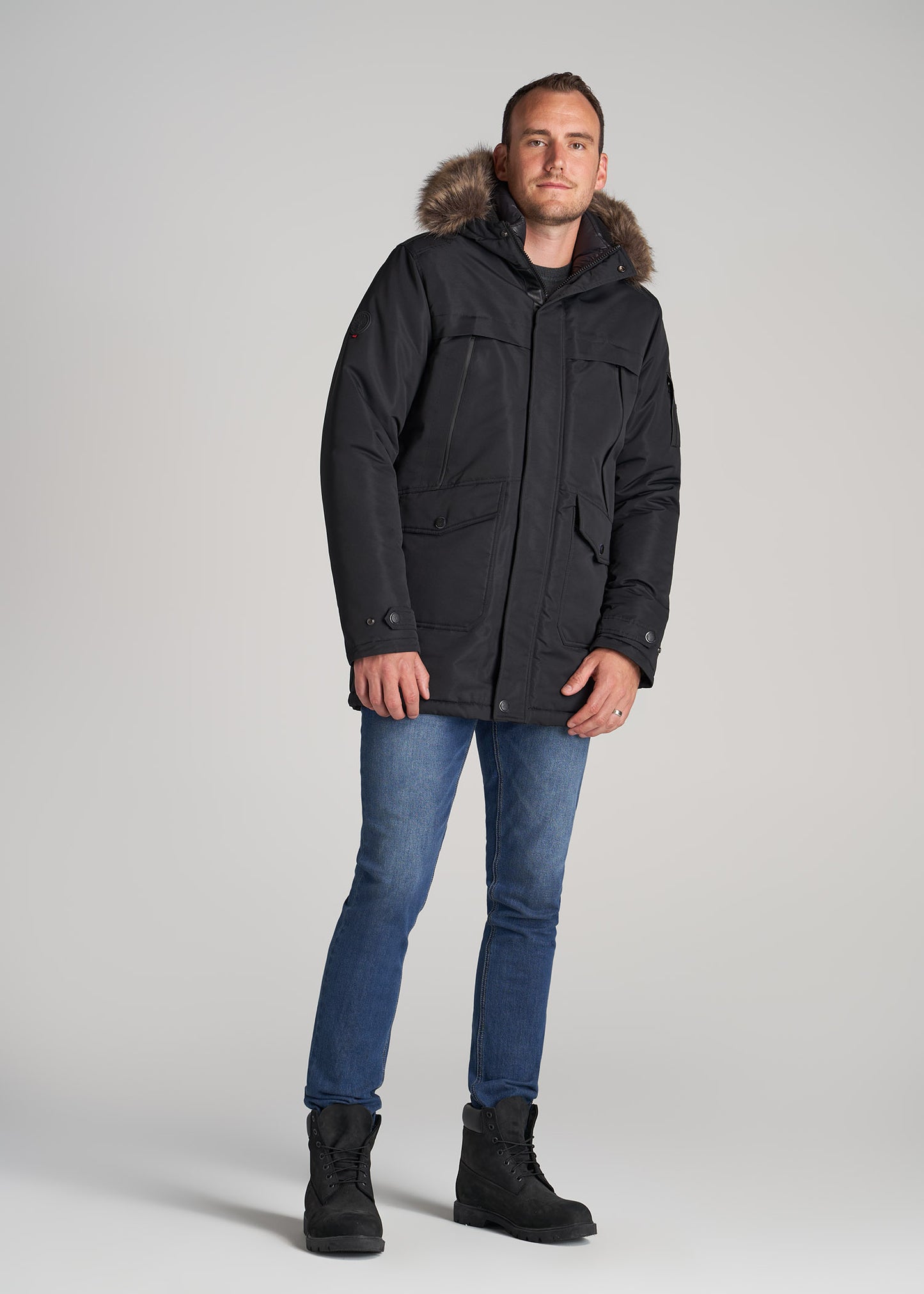 Tall man wearing the American Tall X Point Zero Parka in Black
