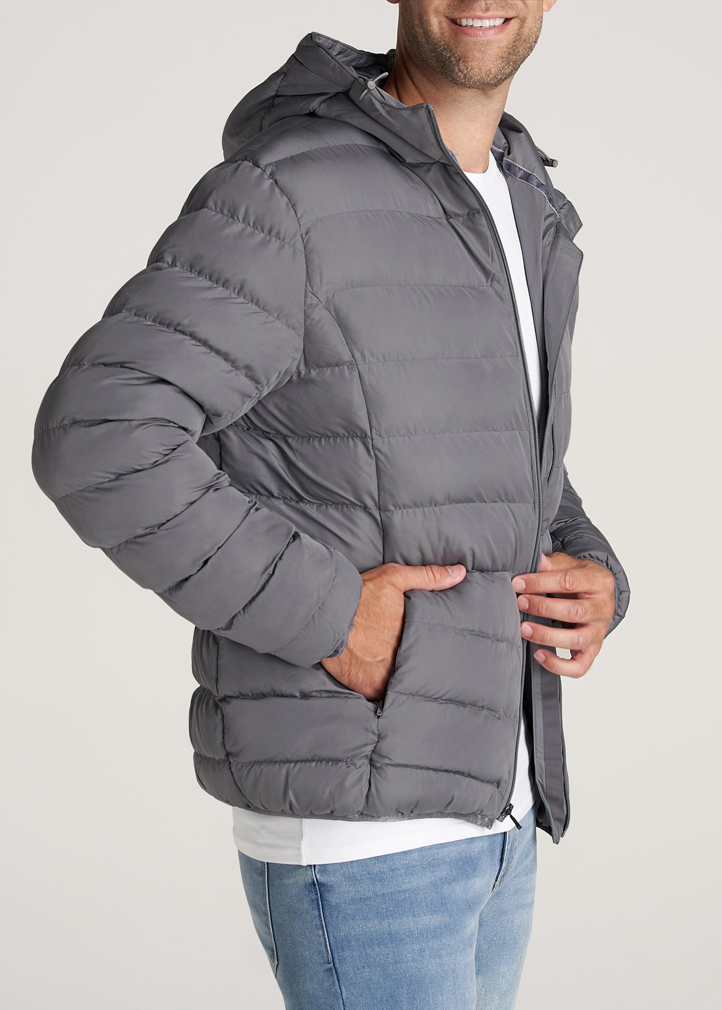 A tall man wearing American Tall's Medium-Weight Tall Puffer Jacket for Men in Charcoal.