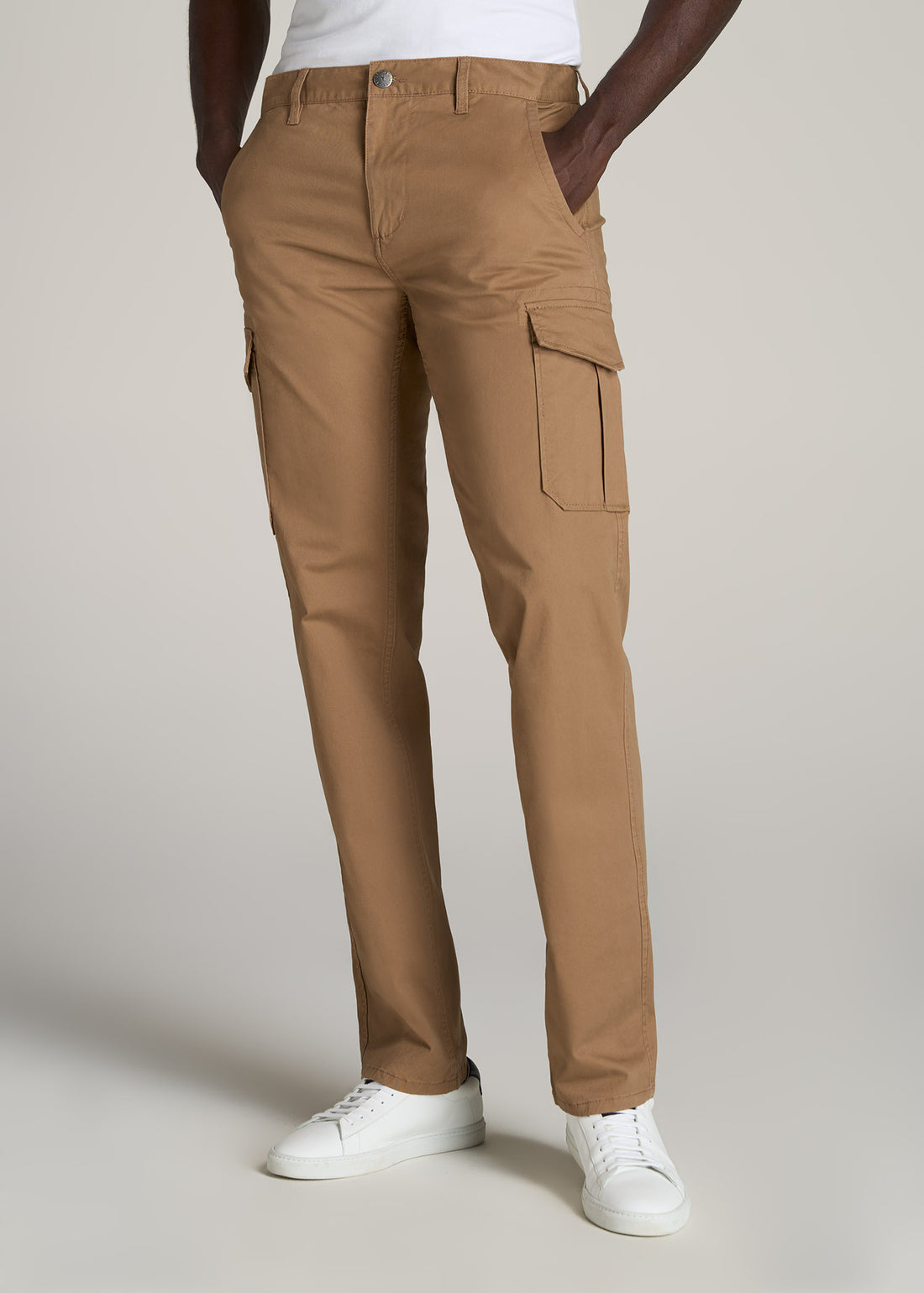Tall man wearing stretch twill cargo pants in light brown.