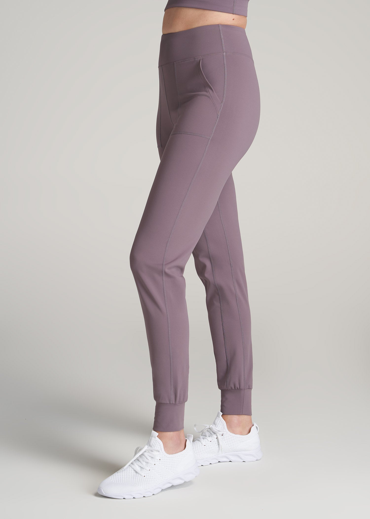 A tall woman wearing American Tall's AT Balance Pocket Joggers in the color Smoked Mauve.