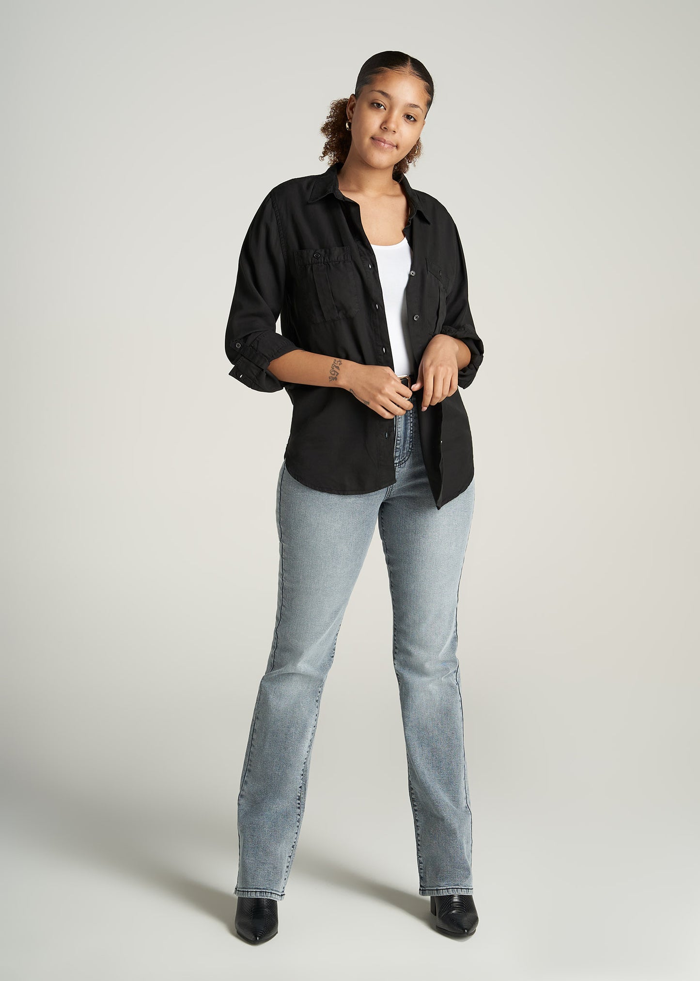 A tall woman wearing American Tall's Tencel Button Shirt in the color Black.