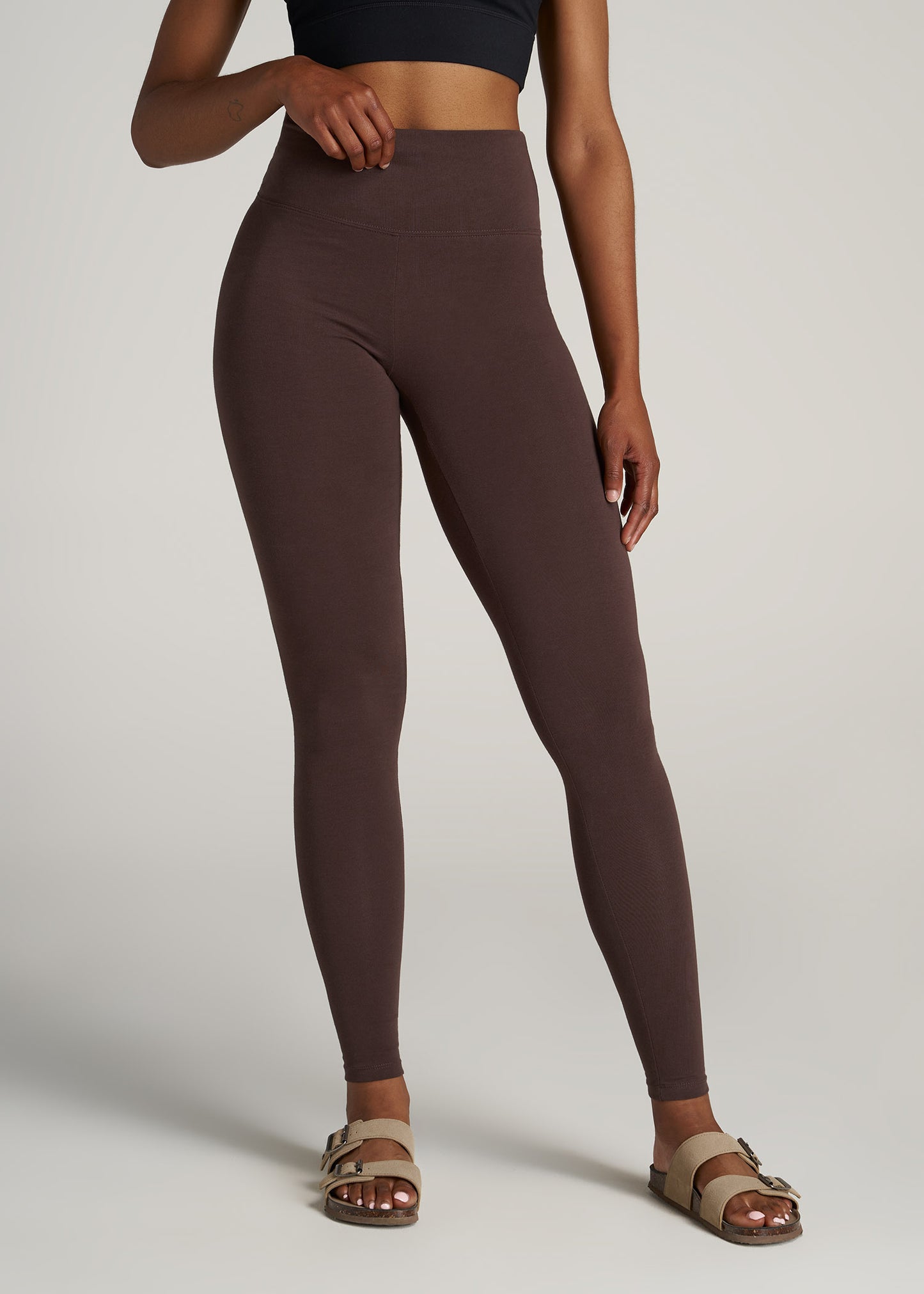 A tall woman wearing American Tall's Cotton Legging in the color chocolate.