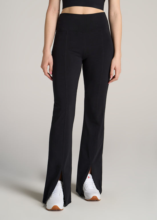 A tall woman wearing American Tall's Textured Back Pocket Legging in black charcoal.