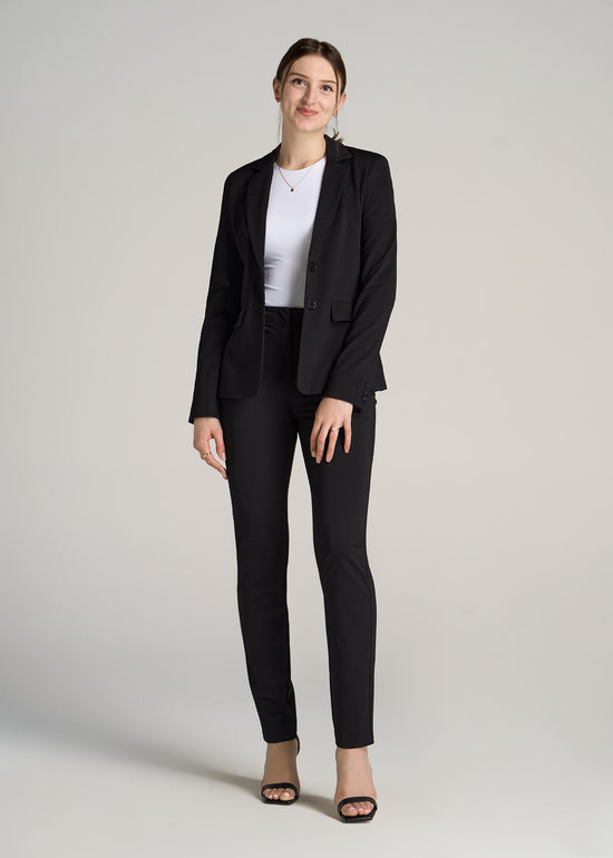 A tall woman wearing American Tall's Slim-Fit Two Button Blazer in the color Black.